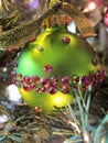 Green Christmas bulb with red crystals and velvet glitter ribbon, vertical Royalty Free Stock Photo