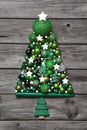 Green christmas decoration with wood: tree of balls on grey back Royalty Free Stock Photo