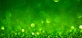 Green Christmas lights background, banner design. Shiny glowing surface with bokeh, abstract defocused glitter with Royalty Free Stock Photo