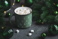 Green Christmas Mug with Hot Chocolate and Marshmallows into Pine Decor Royalty Free Stock Photo