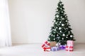 Green Christmas tree with gifts of toys for the new year holiday decor winter Royalty Free Stock Photo