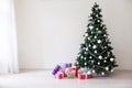 Green Christmas tree with gifts of toys for the new year holiday decor winter Royalty Free Stock Photo