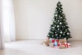 Green Christmas tree with gifts of toys for the new year holiday decor winter Royalty Free Stock Photo