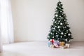 Green Christmas tree with gifts of toys for the new year holiday decor winter Royalty Free Stock Photo