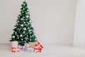 Green Christmas tree with gifts of toys for the new year holiday decor winter Royalty Free Stock Photo