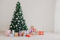 Green Christmas tree with gifts of toys for the new year holiday decor winter Royalty Free Stock Photo