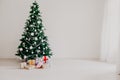 Green Christmas tree with gifts of toys for the new year holiday decor winter Royalty Free Stock Photo