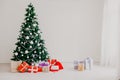 Green Christmas tree with gifts of toys for the new year holiday decor winter Royalty Free Stock Photo