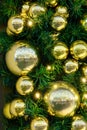 Green Christmas tree with gold balls, xmas decorations on new year