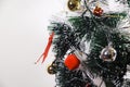 Green Christmas tree with red and gold and silver ornaments. Royalty Free Stock Photo