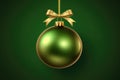 AI generated. Green Christmas tree toy ball with festive golden bow ribbon on dark background with copy space Royalty Free Stock Photo