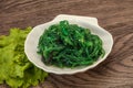 Green Chuka Seaweed Salad Isolated on White Background Top View. Wakame Sea Kelp Salat