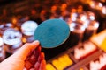 Green circle coaster paper holding with left hand with blur background