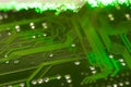 Green circuit board close up shot, defocused optical fibre. Royalty Free Stock Photo