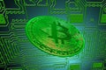 green circuit board and a valueable green bitcoin from crypto currency oblique