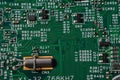 Green circuit board with various electronic components Royalty Free Stock Photo