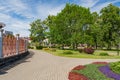 Green city park with walking paths, trees and flowers Royalty Free Stock Photo