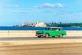 Green classic American car on street of Havana