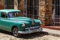 Green classic car in the streets of Trinidad, Cuba