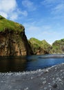 Green cliff and lake