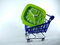 Green clock inside blue shopping trolly isolated on a white background.