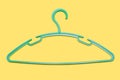 The green clothes hanger is empty without clothes on yellow background close-up Royalty Free Stock Photo