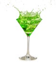 Green cocktail splashing in martini glass Royalty Free Stock Photo