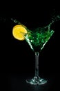 Green cocktail water drink splash in the glass with lemon Isolated on black Royalty Free Stock Photo