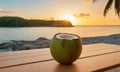 Green coconut against the backdrop of sunset on the sea