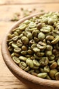 Green coffee beans in wooden bowl on table, closeup Royalty Free Stock Photo