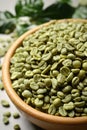 Green coffee beans in wooden bowl on table, closeup Royalty Free Stock Photo