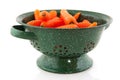 Green colander with fresh carrots