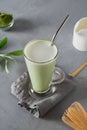 Green cold matcha tea with milk in latte glass on grey table. Close up. View from above Royalty Free Stock Photo
