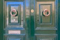 Green color doors and two round brass door knocker Royalty Free Stock Photo