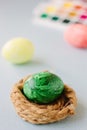 Green color easter egg in small nest over bright background Royalty Free Stock Photo