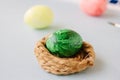 Green color easter egg in small nest over bright background Royalty Free Stock Photo