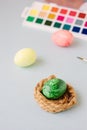 Green color easter egg in small nest over bright background Royalty Free Stock Photo
