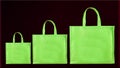 Green Color Handle loop Non woven eco friendly shopping bags on black background Royalty Free Stock Photo