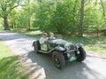 Green color Morgan 4-4 Roaster, serie 1 classic car from 1936 driving on a country road