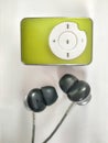 Green color mp3 player with black and grey headphones Royalty Free Stock Photo