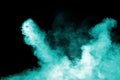 Green color powder explosion on black background.