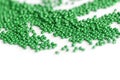 Green color seed beads scattered on a white. Abstract background Royalty Free Stock Photo