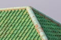 Green colored curved clay roof tiles with ridge corner. Royalty Free Stock Photo