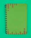 Green colored note paper diary placed on top of a light blue paper background Royalty Free Stock Photo