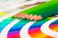 Green colored pencils and color chart Royalty Free Stock Photo