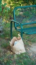 street bench made of metal with a paper bag from a fast food restaurant with rubbish left next to iton the street on a fine autumn