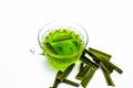 Green colored tea of lemon grass in a transparent cup isolated on white used in many ayurvedic treatments.