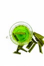 Green colored tea of lemon grass in a transparent cup isolated on white used in many ayurvedic treatments.