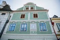 Green colorful renaissance historical house with a picture of the Virgin Mary in the center of Cesky Krumlov, South Bohemia, Czech