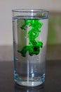 Green Coloring In A Glass Of Water Royalty Free Stock Photo